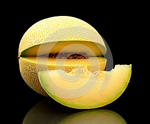 Melon galia notched with slice isolated black in studio