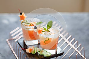 Melon juice, lemonade garnished with cucucmber slice, fresh summer drink