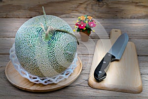 Melon and knife on cutting board