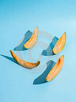 Sliced pieces of melon on blue background