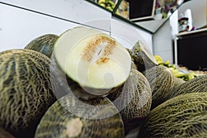 A melon split in half on a pile of melons photo