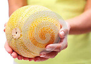 Melon in woman hands.