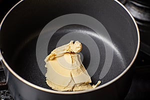 Melt the butter in a saucepan. The initial stage of preparing the sauce