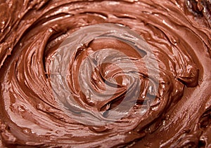 Melted chocolate. Chocolate swirl. Liquid chocolate as background