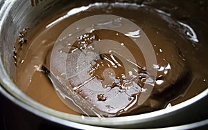 Melted chocolate in pan under a water bath. Making hot chocolate at home in your own kitchen