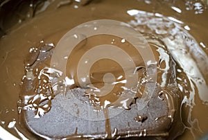 Melted chocolate in pan under a water bath. Making hot chocolate at home in your own kitchen