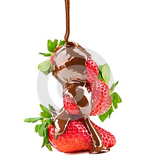 Melted chocolate pouring on strawberries