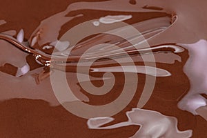 Melted chocolate swirl background. Liquid chocolate close-up photo