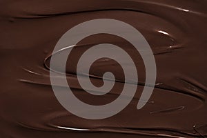 Melted chocolate texture, full-frame. Dark chocolate swirl background