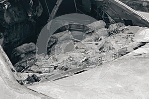 Melted head restraints and rear window of burned out car