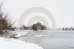 Melted ice on the spring river, winter landscape