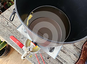 Melting beeswax in wax heater.