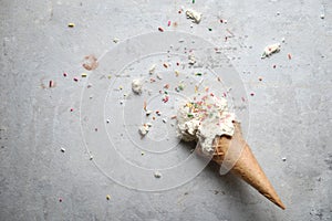 Melting coconut ice cream scoops and waffle cone. top view