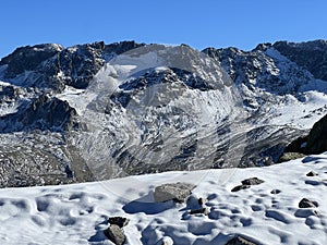 The melting of fresh autumn snow in the wonderful environment of the Swiss mountain massif Abula Alps, Zernez photo