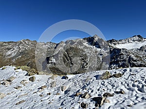 The melting of fresh autumn snow in the wonderful environment of the Swiss mountain massif Abula Alps, Zernez photo