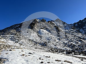 The melting of fresh autumn snow in the wonderful environment of the Swiss mountain massif Abula Alps, Zernez photo