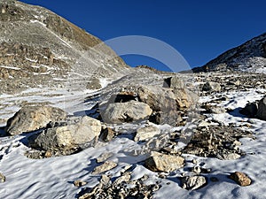 The melting of fresh autumn snow in the wonderful environment of the Swiss mountain massif Abula Alps, Zernez photo