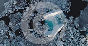 Melting glacier in frozen polar ocean aerial view