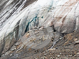 Melting glacier texture. Minimalist nature background of glacier surface with big cave and cracks. Minimal natural backdrop of icy