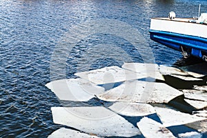 Melting ice blocks in river in spring