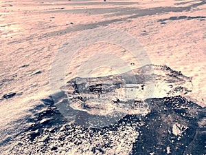 Melting ice crystals and icebergs. The beach covered by thick ice