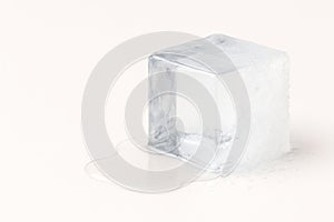 A melting ice cube on a light background. Space for text.