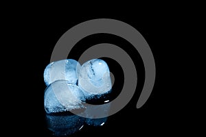 Melting ice cubes on black background