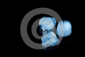 Melting ice cubes on black background