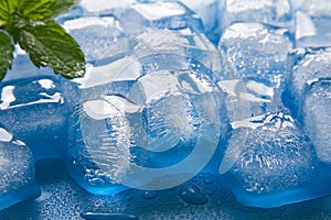 Melting ice cubes close up on blue background