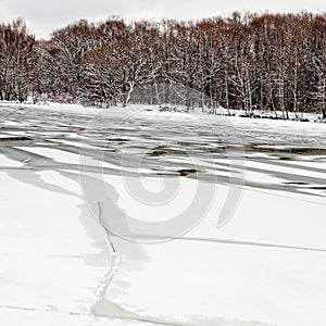 Melting ice on frozen river