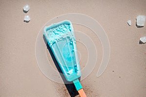 A melting ice pop color staining the hot sidewalk
