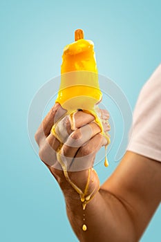 Melting Ice Pop Held by a Hand