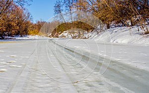 Melting ice on the Spring River in the woods sunny day.