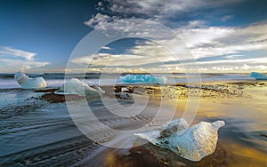 Melting Icebergs on the Shore at Sunset