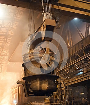 Melting of metal in a steel plant. High temperature in the melting furnace. Metallurgical industry.