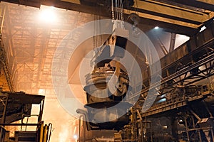 Melting of metal in a steel plant. High temperature in the melting furnace. Metallurgical industry.