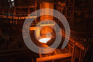 Melting of metal in a steel plant. High temperature in the melting furnace. Metallurgical industry. Factory for the