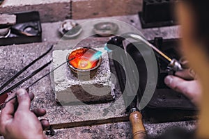 Melting precious metals in the crucible. Workflow in a jewelry workshop photo