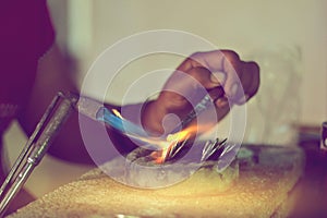 Melting silver in craft jewellry making, handmade silverware process photo