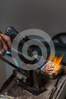 Melting Silver Grains in crucible with blowtorch photo