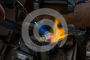 Melting a Silver Ingot in crucible with blowtorch; photo