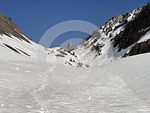 Melting snow cover and early spring ambience in the alpine valley Lochboden and in the valley of the stream Sulzbach in the Glarus