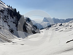 Melting snow cover and early spring ambience in the alpine valley Lochboden and in the valley of the stream Sulzbach in the Glarus