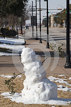 Melting snowman on public downtown street in Abilene, TX photo