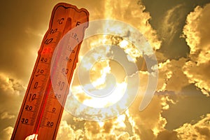 Melting street thermometer against bright summer sun.High temperature.Summer heat.Concept of global warming.