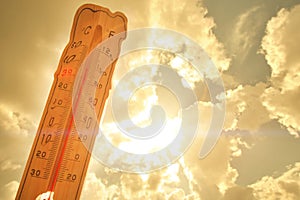 Melting street thermometer against bright summer sun.High temperature.Summer heat.Concept of global warming