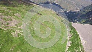 Meltwater forming lake in mountains. Clip. Top view of amazing mountain landscapes with meltwater coming from snowy