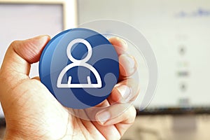 Member icon blue round button holding by hand infront of workspace background