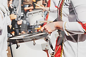 Member of a military fanfare playing a mobile bass drum on a par photo