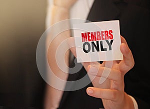 MEMBERS ONLY on a card Businessman holds. VIP clients in business concept
